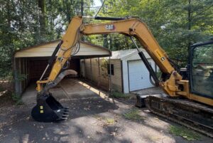 a large machine tearing down a buiilding in charlotte north carolina operated by one stop dumpsters and demo
